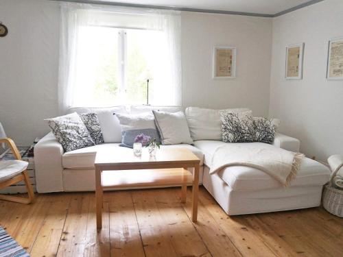 a living room with a white couch and a table at 6 person holiday home in HALLABRO-By Traum in Hallabro