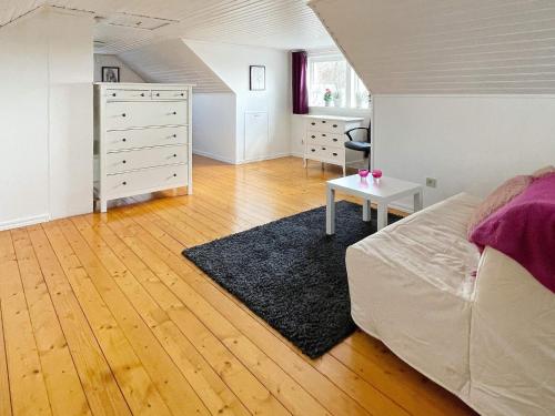 a bedroom with a bed and a dresser and a desk at 4 star holiday home in FäRJESTADEN in Färjestaden