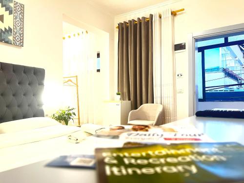 a room with a bed and a table with a chair at Tirana Square Hotel in Tirana