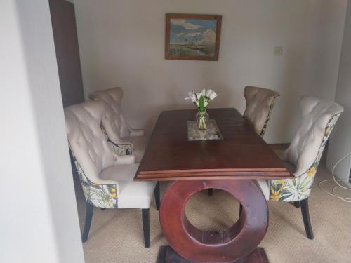 a dining room with a table and some chairs at Peaamb GuestHouse - Springs Golf Club in Springs