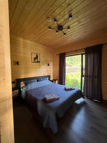 a bedroom with a bed and a ceiling fan at Котедж “Гуркало" in Korchin