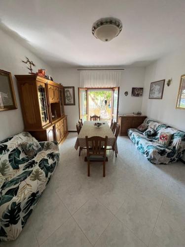 a living room with a table and a couch at Ciotti Rosella affittacamere in Acquaviva Picena