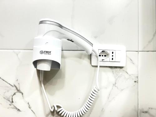 a telephone on a wall in a bathroom at Tirana Square Hotel in Tirana
