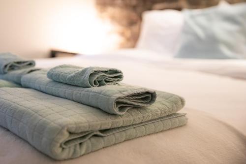 two towels sitting on top of a bed at KingstonStays Spacious Historic Downtown Stableman's House Loft in Kingston