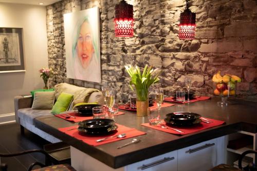 a dining room with a table with plates and glasses at KingstonStays Spacious Historic Downtown Stableman's House Loft in Kingston