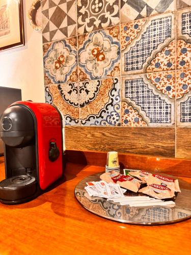 a red toaster sitting next to a plate on a table at Marsala al centro n 9 in Marsala
