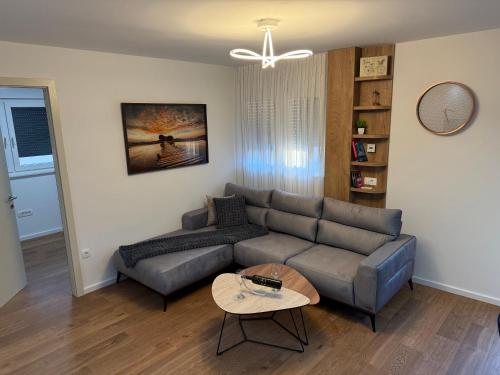 a living room with a couch and a table at Luxury apartment Gabi 1 in Slavonski Brod