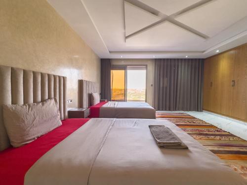 a hotel room with two beds and a window at Tayyurt host in Agadir