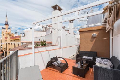 a balcony with a view of the eiffel tower at Apartamentos Mayor by HABAMA in Sitges