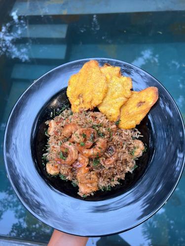 a bowl of food with fried food and rice at Rincon de la Sierra Minca in Minca