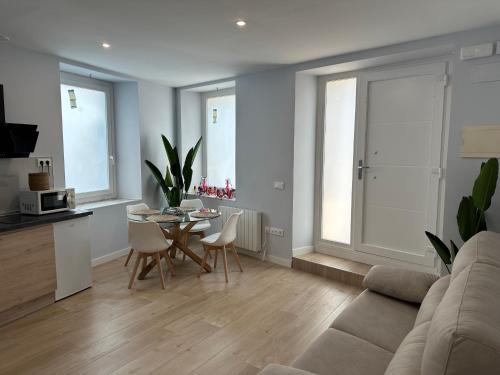 a living room with a couch and a table and chairs at Apartamento Puente de Piedra Logroño in Logroño
