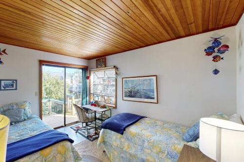 a bedroom with two beds and a wooden ceiling at Hill Villa in Newport