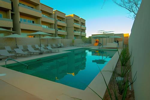 a swimming pool in front of a hotel at Condominios Evamar San Carlos in San Carlos