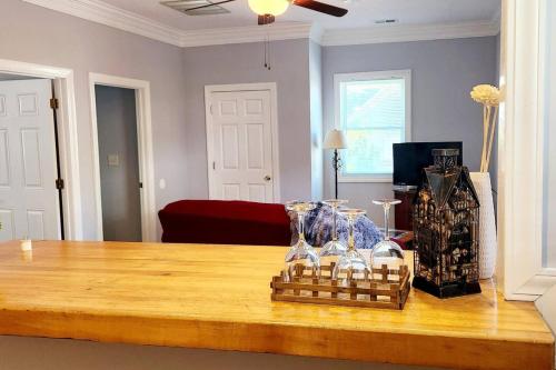 a living room with a wooden table and a room with a couch at Charming Cute Convenient 2 mi to Downtown and UGA in Athens