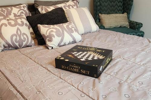 a book sitting on top of a bed at Charming Cute Convenient 2 mi to Downtown and UGA in Athens