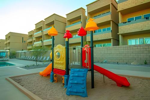 a playground in front of a apartment building at Condominios Evamar San Carlos in San Carlos
