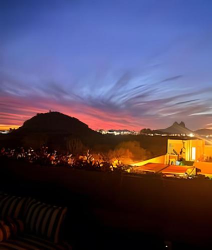 a sunset over a city with a mountain in the background at Condominios Evamar San Carlos in San Carlos