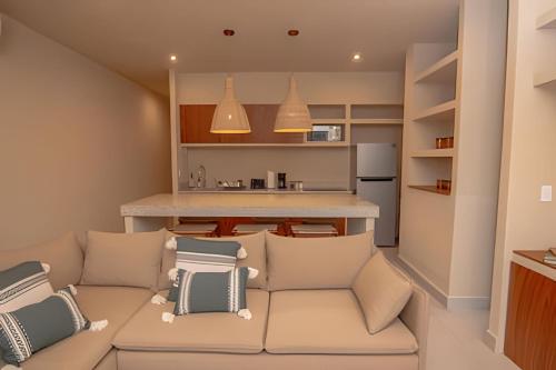 a living room with a couch and a kitchen at Condominios Evamar San Carlos in San Carlos