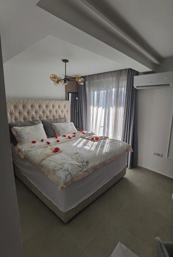 a bedroom with a bed with red roses on it at Pavlovic Luxury Spa in Vrnjačka Banja