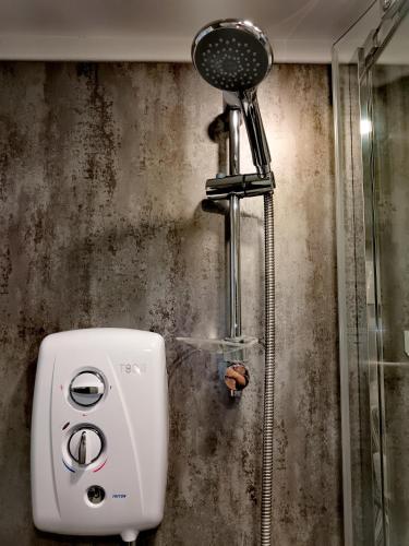 a shower in a bathroom with a blow dryer at Garden Guesthouse, Sleep4, Private Entrance, Parking, Wifi, AirCon, Derby City in Derby