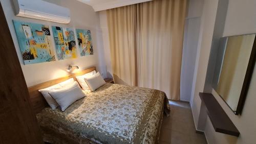 a hotel room with a bed and a television at Bonito House 2 in Kemer
