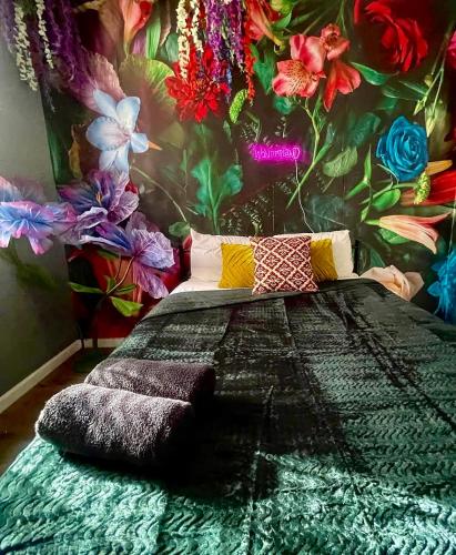 a bedroom with a bed with a flower wall at Garden Hideaway Minutes to Fishtown in Philadelphia