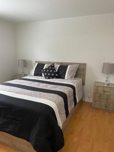 a bedroom with a large bed with pillows on it at Maison Carofanne in Saint-Siméon