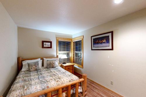 a bedroom with a bed and a window at The Hawk Nest in Klamath Falls