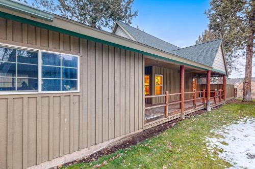 a house with a large porch with a deck at The Hawk Nest in Klamath Falls