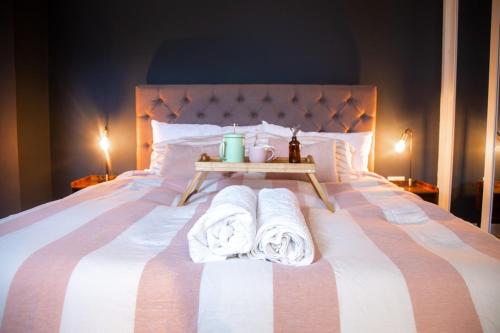 a bedroom with a bed with towels on it at Stylish Padstow Townhouse in Padstow