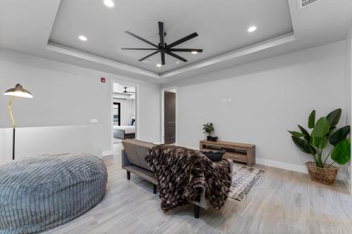 a bedroom with a bed and a ceiling fan at Desert Sands l Private Spa l Sleeps Twelve in Hurricane