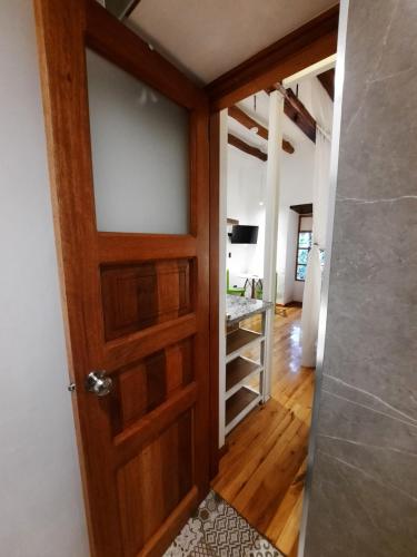 a door leading into a room with a hallway at Hostal Suite Le Fabrique in Cuenca