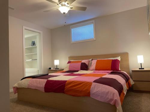 a bedroom with a bed and a ceiling fan at Welcome to Shibly's Retreat in Edmonton