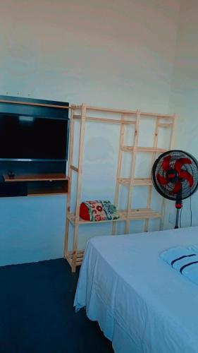 a bedroom with a bed and a bunk bed with a ladder at Chalé marlin azul in Icapuí