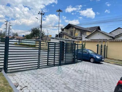 a blue car parked in front of a fence at Aeropuerto Internacional Quito Habitacion #2 in Pifo