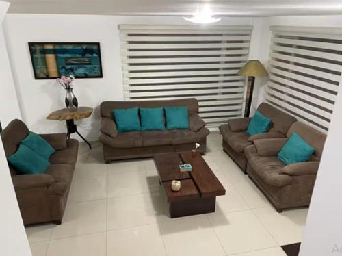 a living room with two couches and a coffee table at Aeropuerto Internacional Quito Habitacion #2 in Pifo