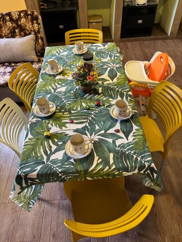 a table with a table cloth with cups and saucers at Mariposas in Chignahuapan
