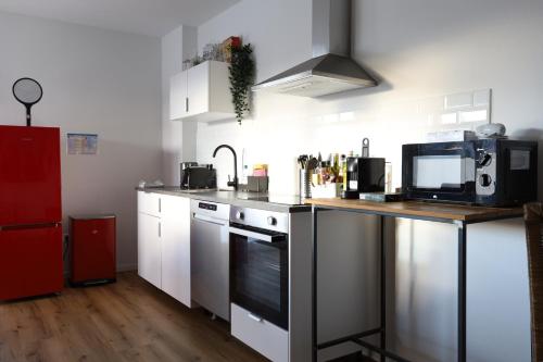 a kitchen with white cabinets and a counter with a microwave at Apartment "New York" in Erftstadt - 3 Zimmer & 91qm - nahe Köln, Messe, Phantasialand & Bonn - Familienurlaub oder Business Trip in Erftstadt
