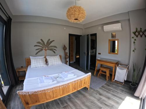 a bedroom with a large bed and a table at Akyaka Kitesurf Villas 1 Tüm Villa Özel Havuz ve Bahçeli in Mugla