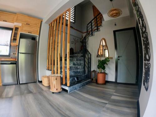 a living room with a staircase in a house at Akyaka Kitesurf Villas 1 Tüm Villa Özel Havuz ve Bahçeli in Mugla