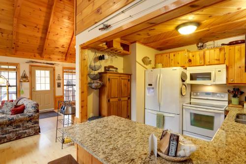 a kitchen with a white refrigerator and a stove at Creek Bend Escape with Hot Tub and River Views! in McCaysville