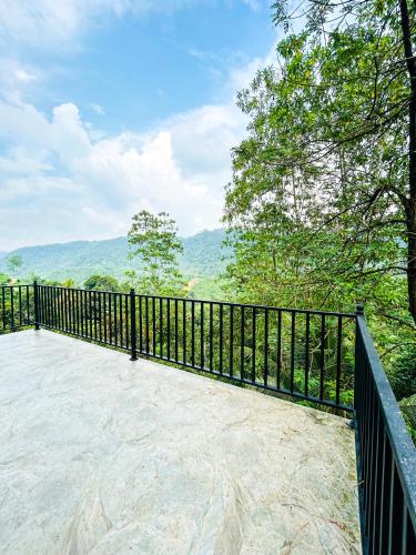 a balcony with a fence and a view of the mountains at Dew Drops Nature Villa in Parakaduwa