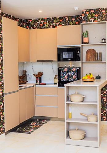 a kitchen with white cabinets and a counter with pots and pans at luxury 1 br 7 mins from Airport, with Gym & Pool in Mamobi
