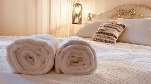 a bed with white towels on it at KingstonStays Historic Downtown Hideaway in Kingston