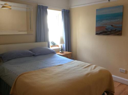 a bedroom with a large bed with a window at An Caislean incorporating Corratavey in Ballycastle