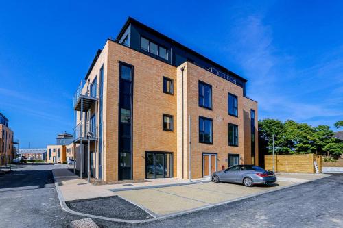 a car parked in front of a brick building at 2bed 2bath In - Next To Station For 6 Free Parking in Ashford