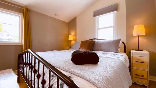 a bedroom with a bed with a heart pillow on it at KingstonStays The Neighbourhood, Expansive loft, free parking in Kingston