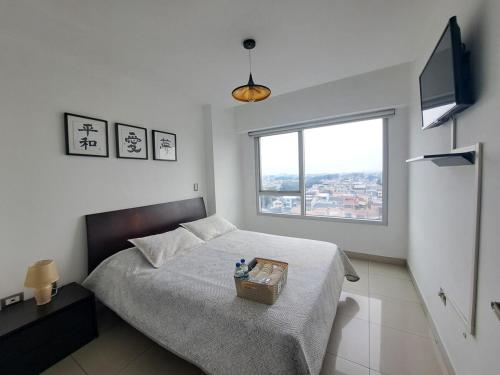 una camera da letto con un letto con un cesto sopra di AMBAR SUITE CON VISTA A LA CIUDAd a Guayaquil