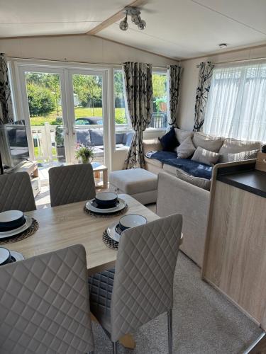 a living room with a table and a couch at Acres Corner Retreat Inc Hot tub at Tattershall Lakes Country Park in Tattershall