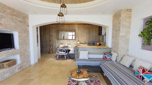 a living room with a couch and a table at Villa - Cantinho do Paraíso in Santo Espírito